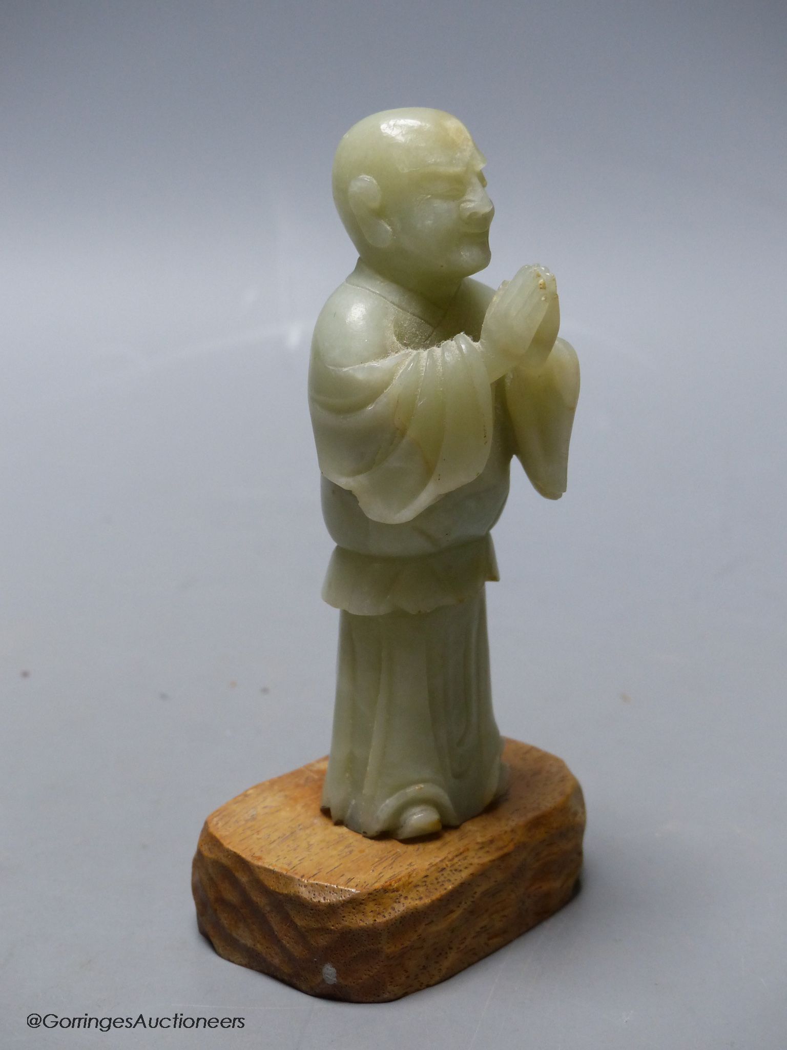 A Chinese celadon jade figure of a priest
